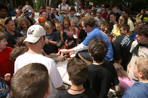 Famous magicians spend a week with the campers teaching them magic || Lee Asher holding Kort.